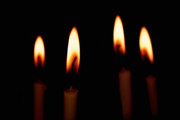 Group of Candles light on black background
