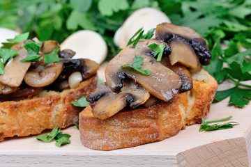 Mushroom bruschetta on chopping board
