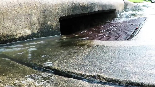 rain water flowing into a storm drain