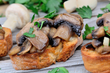 Heap of bruschetta with mushroom and garlic on table