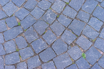 The texture of stone road. Cobblestones.