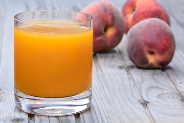 Peach juice in a glass on table