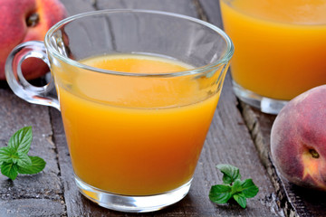 Glasses with peach juice on table