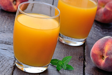Glasses with peach juice on table