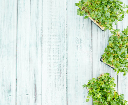 Fresh Cress on wooden background (selective focus)