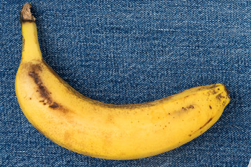 Single banana against denim background