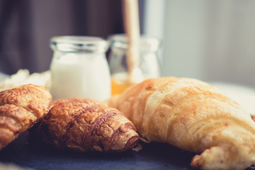 fresh bread and baked goods on wooden chopping board, rustic style