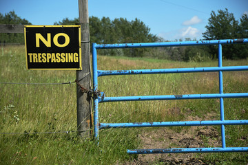 Yellow and Black No Trespassing Sign