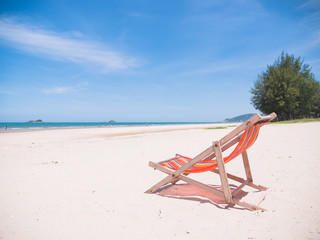 Fototapeta na wymiar Red canvas chair on the beach.