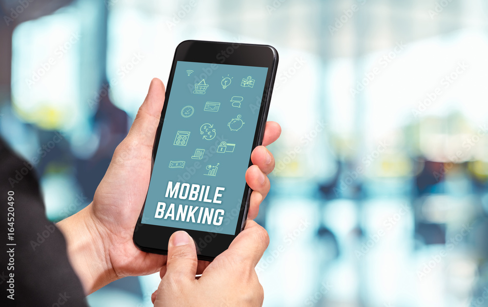 Poster hand holding mobile with mobile banking word and features icon with blur office counter background,d
