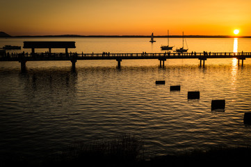 Fototapeta na wymiar Sunset scene of boats and the boardwalk