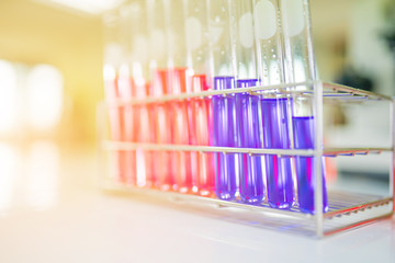 Close-up of colorful chemical test tubes on  tray in medical laboratory