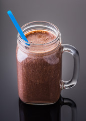 Milkshake chocolate in jar with a straw
