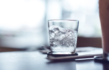 glass with ice on the table.cold filter effect