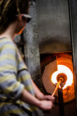 Glassmaker Flashing Piece of Glass in the Kiln