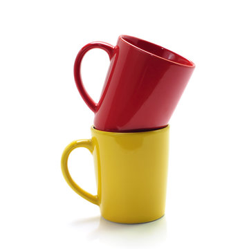 red and yellow mugs isolated on white background