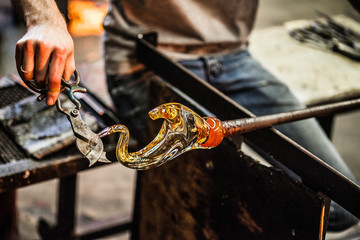 Man Hands Closeup Working on a Blown Glass Piece