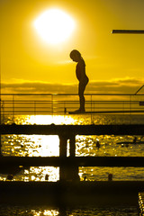 Indecision little girl silhouette on the 3m springboard.