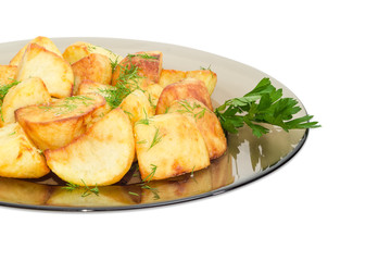 Fried potatoes on the dark glass dish