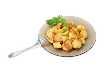 Fried potatoes on dark glass dish with fork