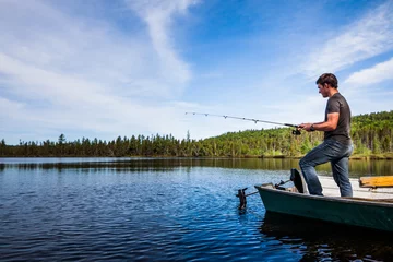Fototapeten Young Adult Fishing trout in a calm Lake © aetb