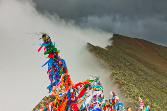 Peaks of rocky mountains in clouds and fog
