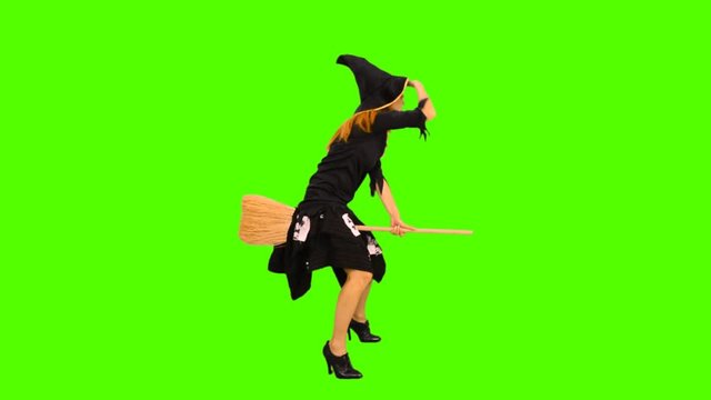 The witch flies on a broomstick greenscreen  shot with alpha channel 
