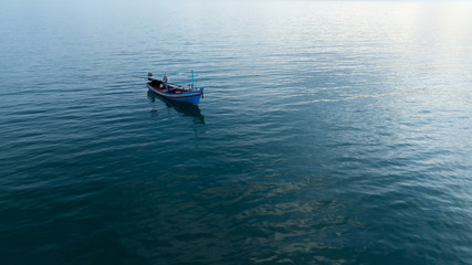 Minimal image of fishing boat on the sea.