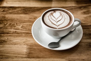 Hot art Latte Coffee in a cup on wooden table