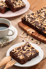 Delicious homemade assorted chewy chocolate fudge brownies with mixed nuts (almond, cashew, macadamia) on baking tray - closeup photography