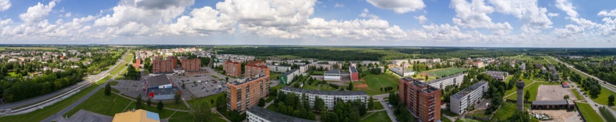 Fototapeta na wymiar Panorama. Aerial photography. Small city landscape, amazing clouds.