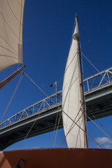 Fototapeta premium Looking Up to Auckland Harbour Bridge through the Sails of Yacht