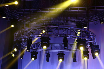 Performance moving lighting on construction light beam ray downward in yellow color