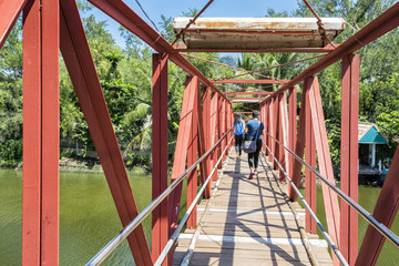 Fototapeta na wymiar Red Metal Hanging Bridge