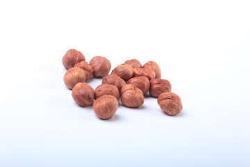 Hazelnuts isolated on white background. Selective focus.