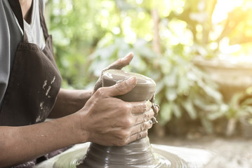 Hands working on pottery wheel