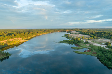Beautiful sunset over the lake in summer forest. Aerial photography.