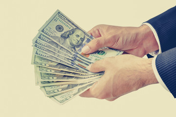 Businessman hands holding money, US dollars (USD)
