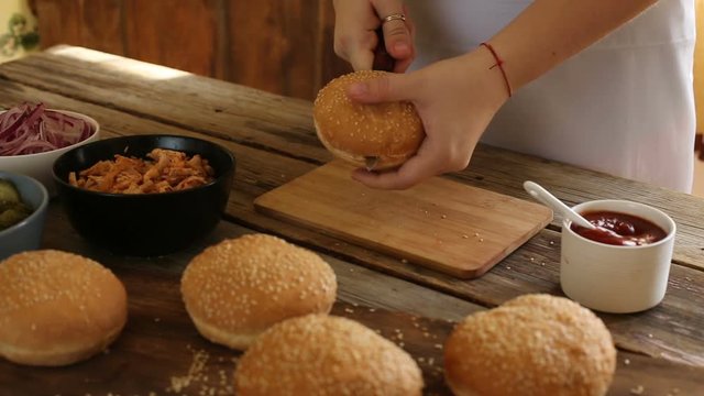 Female hands making fresh hamburger, closeup