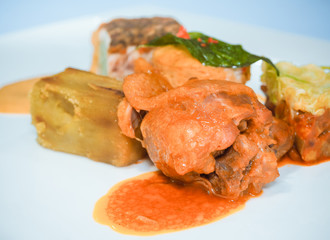 Roasted chicken meat with sauce on a white dish