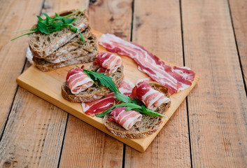 Bread with gourmet meat on a wooden desk.