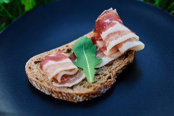 Bread with ham and herbs on a plate.