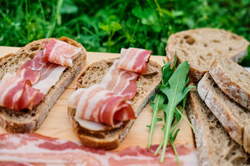 Bread with gourmet meat on a wooden desk.