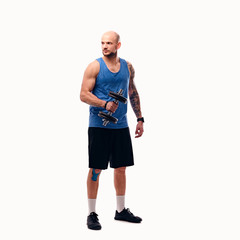 Fototapeta premium Shaved head male holds dumbbell.