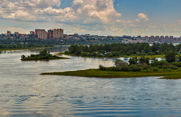 Fototapeta premium Cityscape with river and clouds