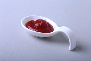 white porcelain bowl of ketchup or tomato sauce isolated on white background.