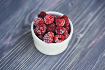 Frozen berry raspberry with white hoarfrost