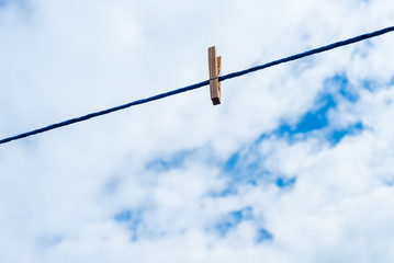 One Laundry clip on rope for hanging on blue sky