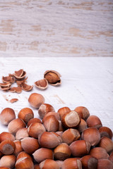 Hazelnuts on white wooden background in studio photo