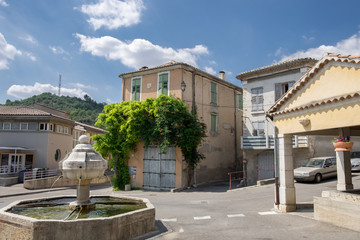 Fototapeta na wymiar Ansient fountain on main square in Riez. Alpes-de-Haute-Provence region, France